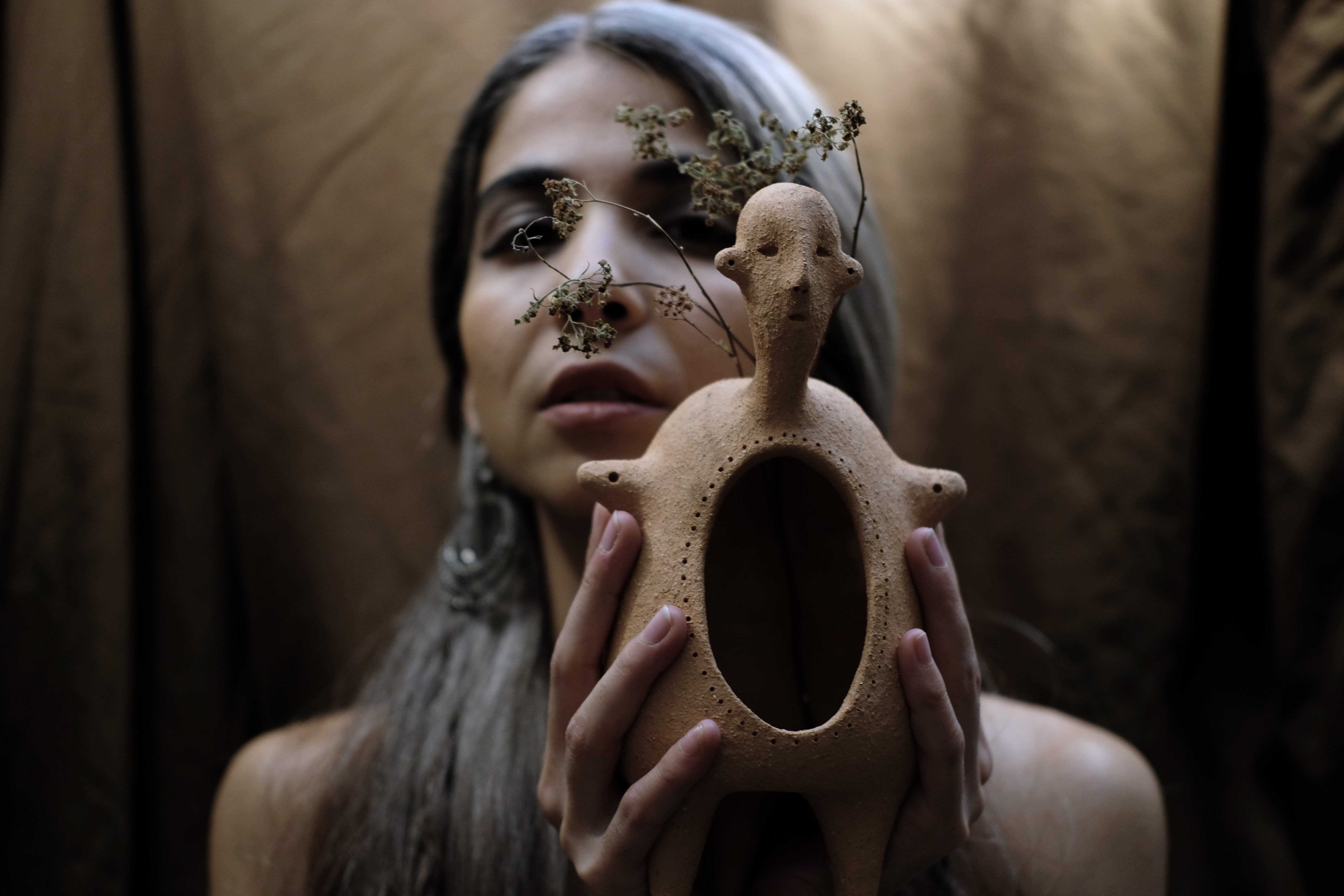 Yasaman holding a handmade clay vessel
